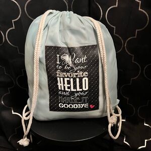 Light Blue Drawstring Backpack with a throw blanket and quote